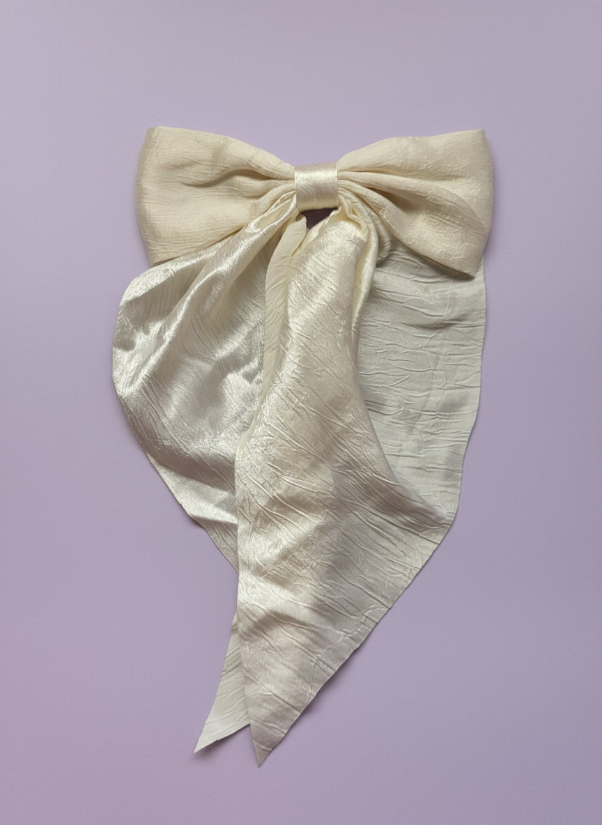 White fabric with a bow on a white surface